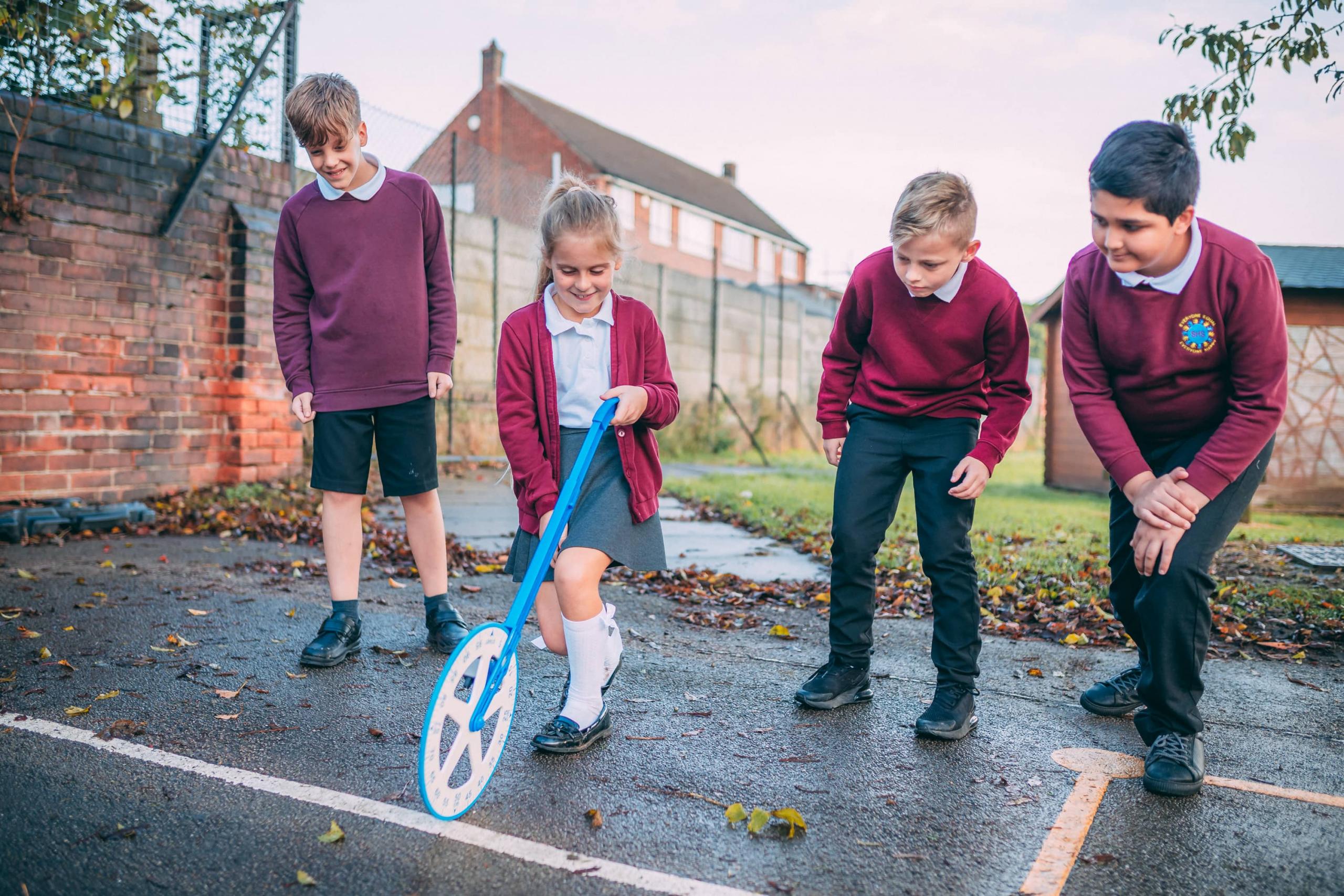 Pupils using a measuring wheel