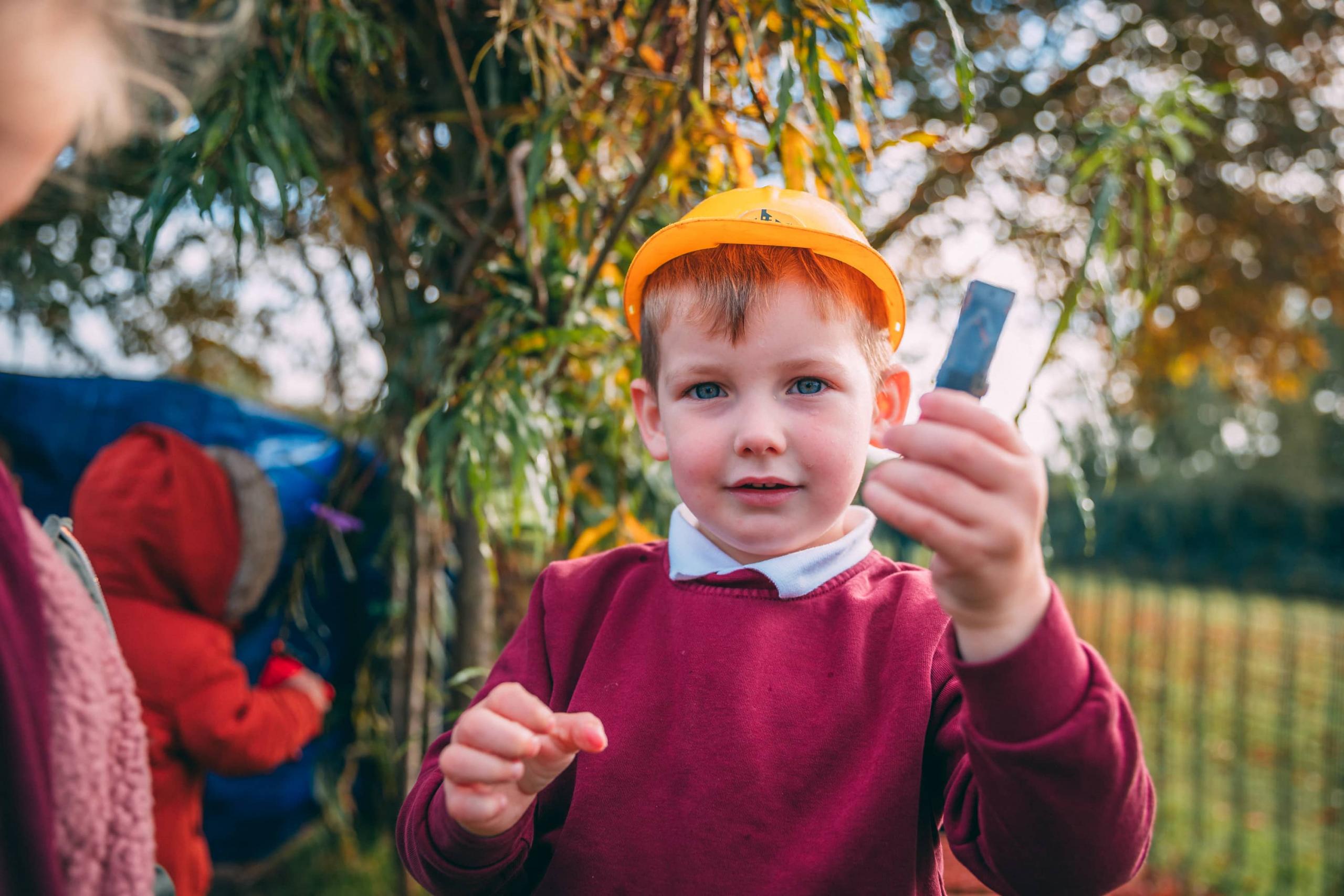 A boy wearing a hard hat